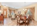 Elegant dining room with a large table and access to the living room at 8836 W Midway Ave, Glendale, AZ 85305