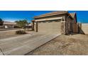 View of the home's exterior, highlighting the garage and landscaping at 10036 W Parkway Rd, Tolleson, AZ 85353