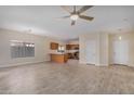 Open floor plan living room with kitchen and tile floors at 10036 W Parkway Rd, Tolleson, AZ 85353