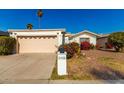 Front view of a single-story house with a two-car garage at 10436 W Devonshire Ave, Phoenix, AZ 85037