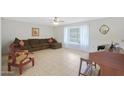 Spacious living room featuring tile floors and a large sectional sofa at 10737 W Hutton Dr, Sun City, AZ 85351