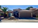 Tan house with tile roof, attached garage, and desert landscaping at 1233 E Redfield Rd, Phoenix, AZ 85022