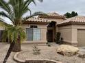 Charming single-story home showcasing a well-maintained exterior with a desert-landscaped front yard at 1233 E Redfield Rd, Phoenix, AZ 85022