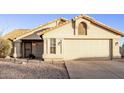 Tan single story house with a two car garage at 169 S Comanche Dr, Chandler, AZ 85224