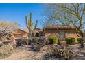 Landscaped front yard with a large saguaro cactus at 17353 N 99Th St, Scottsdale, AZ 85255