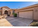 Attached two-car garage with decorative wood doors at 17353 N 99Th St, Scottsdale, AZ 85255