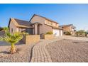 Two-story house with a landscaped walkway and garden at 17463 N 63Rd Dr, Glendale, AZ 85308