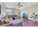 Spacious living room featuring a comfortable sectional sofa and large TV at 17842 W Chuckwalla Canyon Rd, Goodyear, AZ 85338