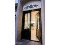 Grand front door opening to a bright, airy living space with elegant chandelier and hardwood floors at 18 W Kaler Dr, Phoenix, AZ 85021