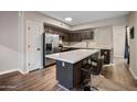 Stylish kitchen island with bar stool seating and stainless steel appliances at 18250 N Cave Creek Rd # 180, Phoenix, AZ 85032