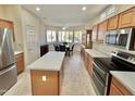 Bright kitchen with an island, stainless steel appliances, and ample counter space at 18328 N Avalon Ln, Surprise, AZ 85374