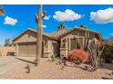 Front view of a single story home with a two car garage at 19601 N Krupps Ct, Maricopa, AZ 85138