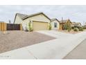 Desert landscaping accents this single-story home with a two-car garage at 2022 W Briana Way, San Tan Valley, AZ 85144