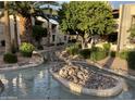 Landscaped courtyard with a serene water feature at 205 N 74Th St # 205, Mesa, AZ 85207