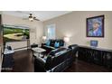 Living room with dark leather furniture and large-screen TV at 2227 W Calle Del Sol --, Phoenix, AZ 85085