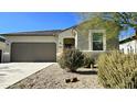 Modern single-story house with a brown garage door and small front yard at 24646 N Barley Rd, Florence, AZ 85132