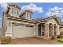 Two-story house with stone accents, and a three-car garage at 2485 S Quaintance St, Gilbert, AZ 85295