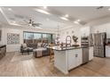 Open concept kitchen with island, stainless steel appliances, and white cabinets at 2485 S Quaintance St, Gilbert, AZ 85295