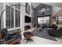 Modern living room with a fireplace and large windows offering natural light at 25150 N Windy Walk Dr # 11, Scottsdale, AZ 85255