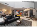 Sophisticated living room featuring a stylish mid-century modern sofa and coffee table at 25150 N Windy Walk Dr # 11, Scottsdale, AZ 85255