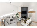 Bright living room featuring a cozy fireplace and ample seating at 29840 N 43Rd Way, Cave Creek, AZ 85331