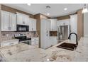 Spacious kitchen featuring granite countertops and white cabinets at 29874 N Little Leaf Dr, San Tan Valley, AZ 85143