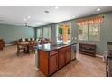 Open concept living and kitchen area with a granite kitchen island, dining table and cozy seating at 3501 E Apricot Ln, Gilbert, AZ 85298