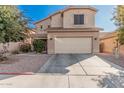 Two-story house with tan exterior, attached garage, and driveway at 3621 W Glass Ln, Phoenix, AZ 85041