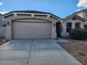 Two-car garage and front door with landscaping at 3919 E Blue Sage Rd, Gilbert, AZ 85297