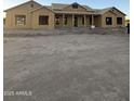 An unfinished single-story home shows its exterior with windows and a porch roof that has posts at 3972 E Hash Knife Draw Rd, San Tan Valley, AZ 85140