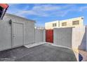 Small patio area with a storage unit and gate at 5406 W Hearn Rd, Glendale, AZ 85306