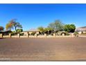 Tan house with a long driveway and rock landscaping at 6416 W Parkside Ln, Glendale, AZ 85310