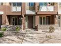 Front entrance of a two-story townhome with a modern design and landscaping at 6605 N 93Rd N Ave # 1082, Glendale, AZ 85305