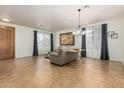 Large living room with tile flooring, neutral paint, gray curtains, and modern furniture at 7461 W Tumblewood Dr, Peoria, AZ 85382