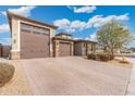 Brick paver driveway leading to a two-car garage at 7718 W Raymond St, Phoenix, AZ 85043