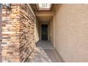 Covered entryway with stone accent wall and iron door at 7718 W Raymond St, Phoenix, AZ 85043