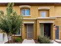 Front view of a tan two-story townhome with a walkway and landscaping at 7820 E Baseline Rd # 103, Mesa, AZ 85209