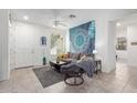 Living room with gray couch, coffee table, and a large tapestry at 7820 E Baseline Rd # 103, Mesa, AZ 85209