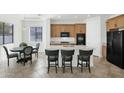 Modern kitchen with island and stainless steel appliances at 7917 S 32Nd Ter, Phoenix, AZ 85042