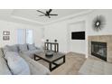 Open concept living room with fireplace and large windows at 7917 S 32Nd Ter, Phoenix, AZ 85042