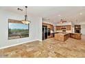 Open-concept kitchen featuring granite countertops, stainless steel appliances, and tile flooring throughout at 817 E Irvine Rd, Desert Hills, AZ 85086