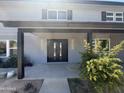Close up of the covered entryway and front door of a freshly painted home at 925 W Fairway Dr, Mesa, AZ 85201