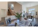 Open-concept living room with hardwood floors, a staircase, and access to the dining room at 9325 E Fairfield St, Mesa, AZ 85207