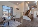 Welcoming living room with high ceilings, a staircase, hardwood floors, and large windows at 9325 E Fairfield St, Mesa, AZ 85207