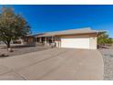 Single story home with attached garage and a rock driveway at 9826 W Emberwood Dr, Sun City, AZ 85351