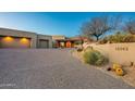 Modern stucco home with a two-car garage and desert landscaping at 10962 E Old Trails Rd, Scottsdale, AZ 85262