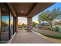 Covered patio with stone pillars and stunning desert views at 10962 E Old Trails Rd, Scottsdale, AZ 85262