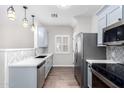 Modern galley kitchen with stainless steel appliances at 13185 W Calavar Rd, Surprise, AZ 85379