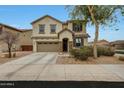 Inviting two-story home featuring a covered entry, two-car garage and lush desert landscaping at 13235 W Tether Trl, Peoria, AZ 85383