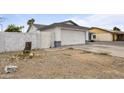 Side view of a single story home showing the garage, side yard, and fence at 13804 N 52Nd Dr, Glendale, AZ 85306